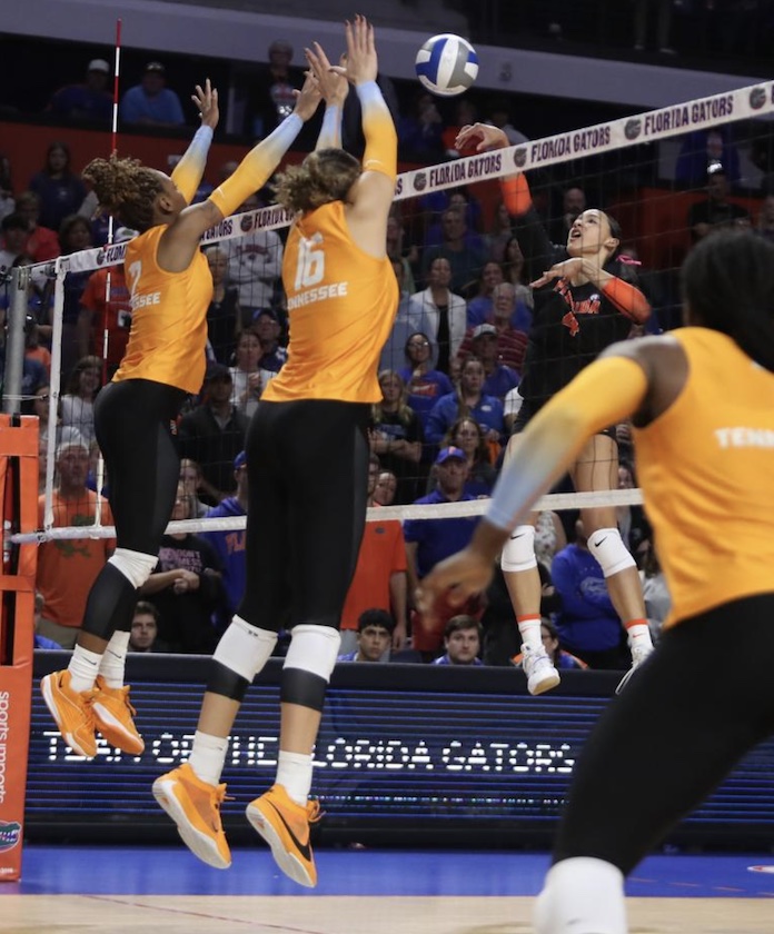 Sofia Victoria of Florida hits against the Tennessee block of Erykah Lovett and Raeven Chase