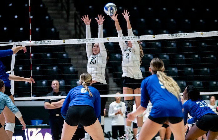 Gracie Duplechein and Hannah Brewer of Southeastern Louisiana put up the block against Texas A&M
